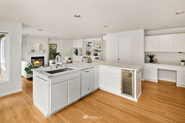 a kitchen with a sink cabinets and wooden floor
