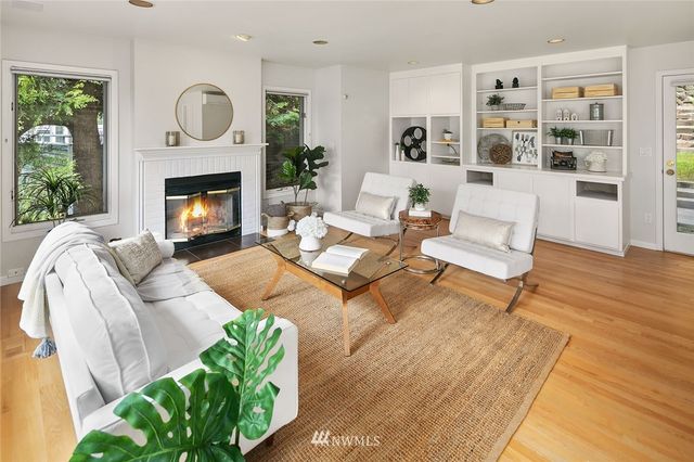 a living room with furniture fireplace and wooden floor