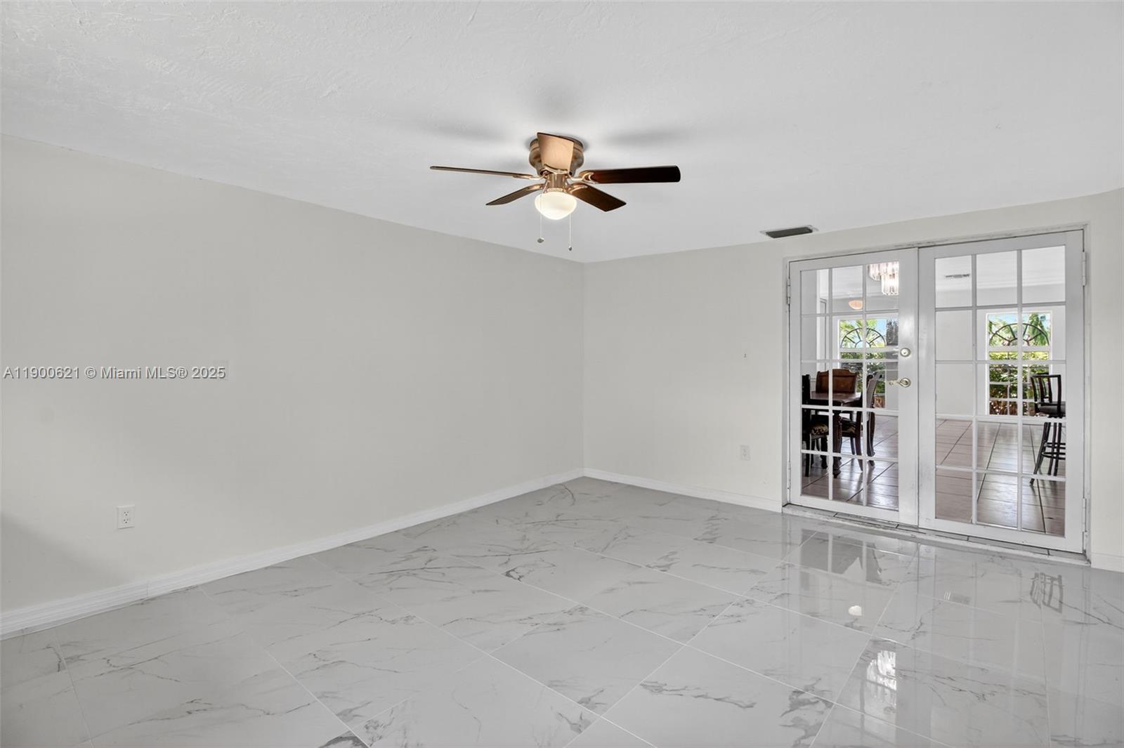 15403 Southwest 107th Court Miami, FL 33157 - Photo 17 of 48 an empty room with chandelier fan and windows