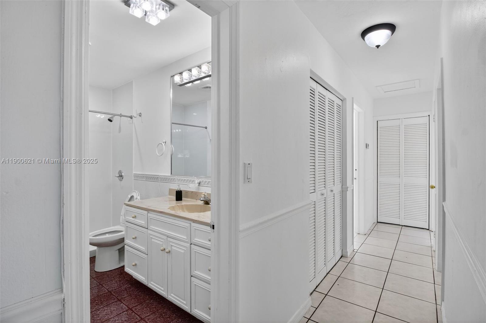 15403 Southwest 107th Court Miami, FL 33157 - Photo 20 of 48 a bathroom with a double vanity sink toilet mirror and window