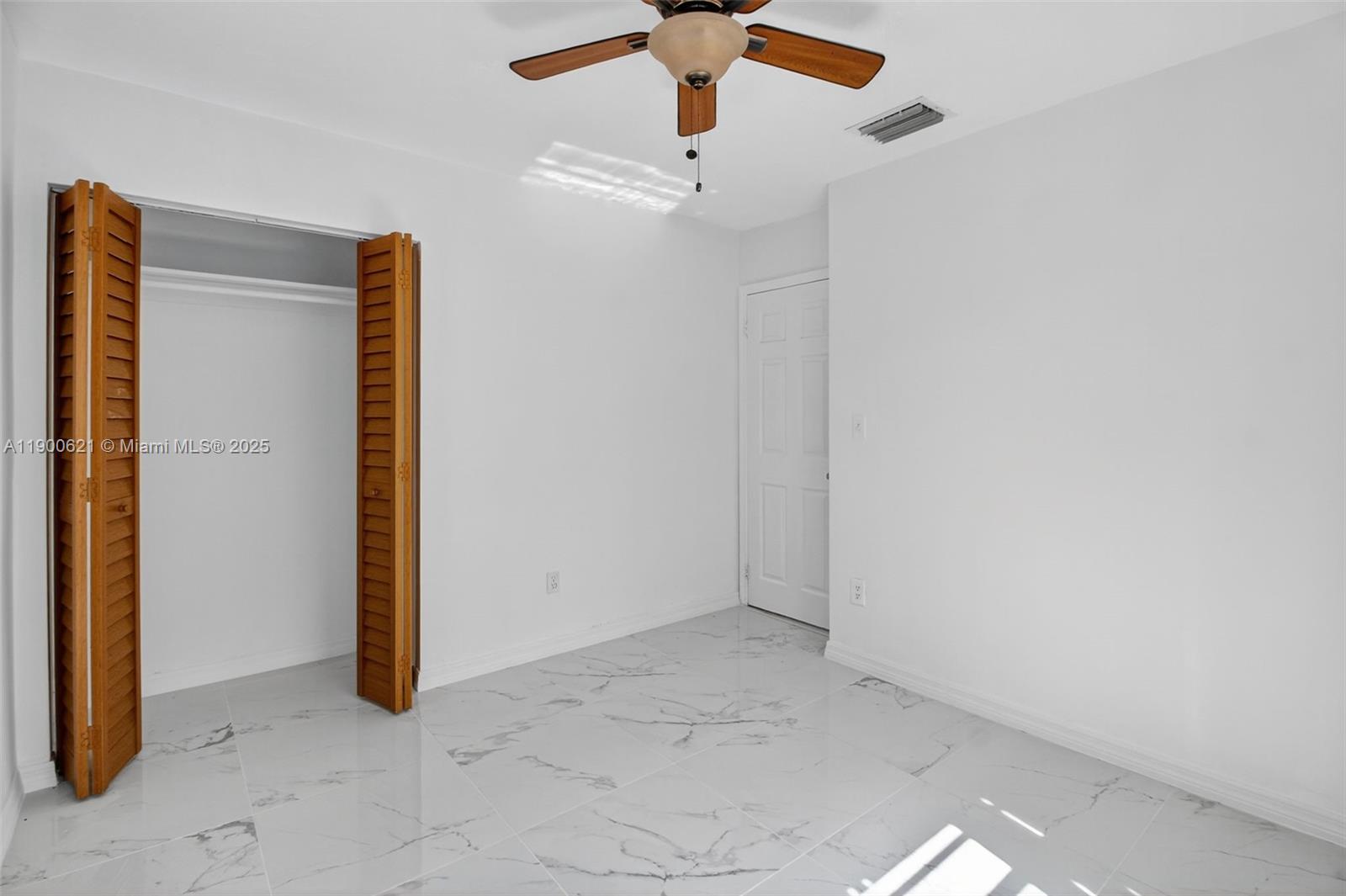 15403 Southwest 107th Court Miami, FL 33157 - Photo 33 of 48 an empty room with a ceiling fan and carpet