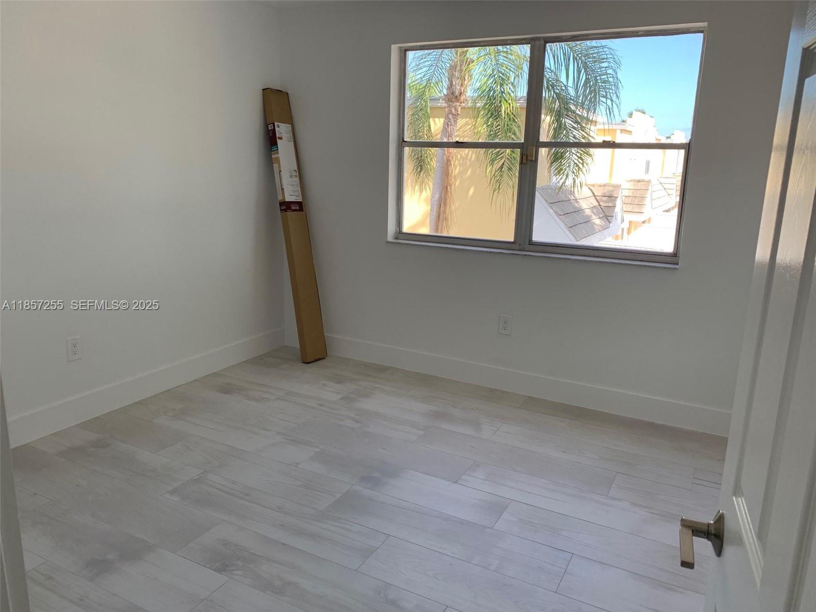 6825 Southwest 45th Lane, Unit 7 Miami, FL 33155 - Photo 11 of 30 an empty room with a window