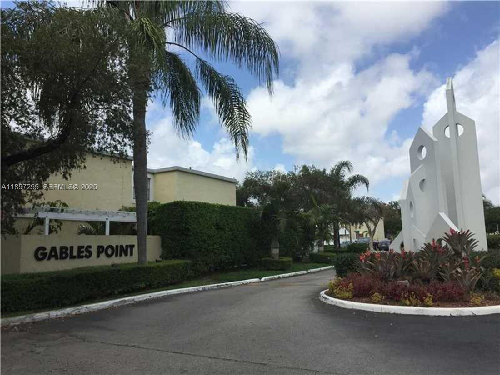6825 Southwest 45th Lane, Unit 7 Miami, FL 33155 - Photo 2 of 30 a palm tree sitting in front of a house with a yard