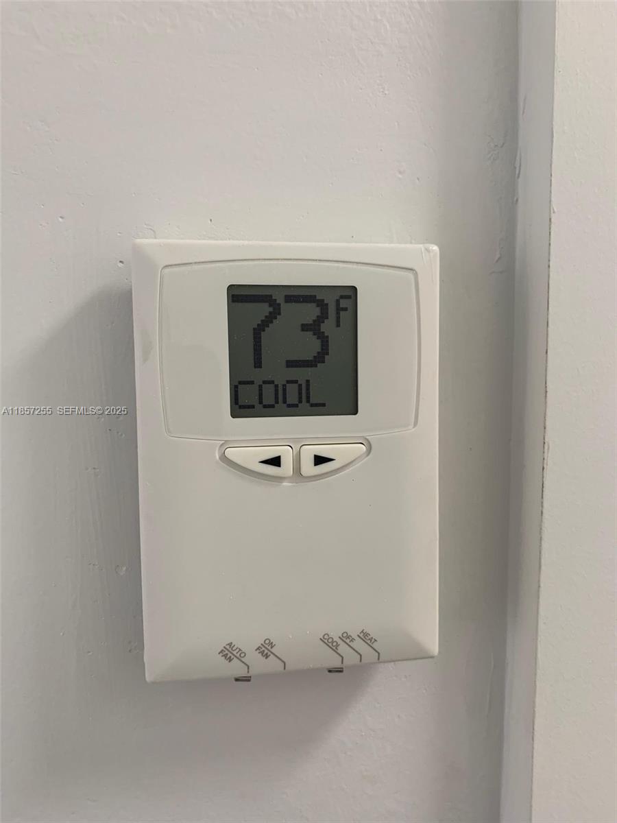 6825 Southwest 45th Lane, Unit 7 Miami, FL 33155 - Photo 29 of 30 a room with a cabinet and mirror