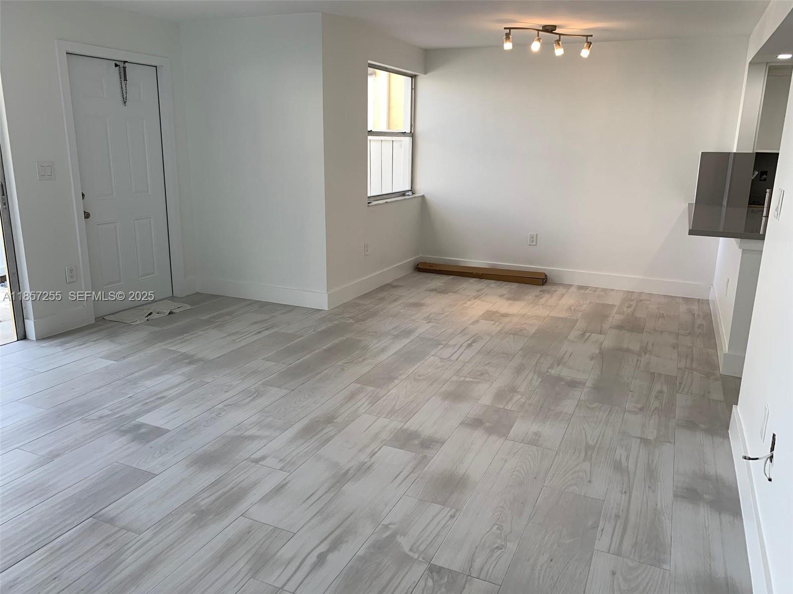 6825 Southwest 45th Lane, Unit 7 Miami, FL 33155 - Photo 6 of 30 a view of an empty room with a window