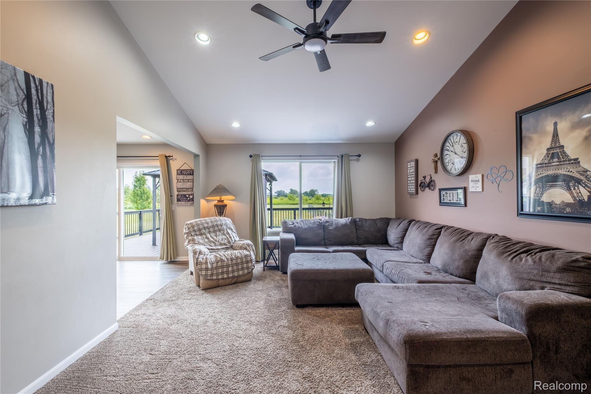 Vaulted ceiling with recessed lighting and ceiling fan