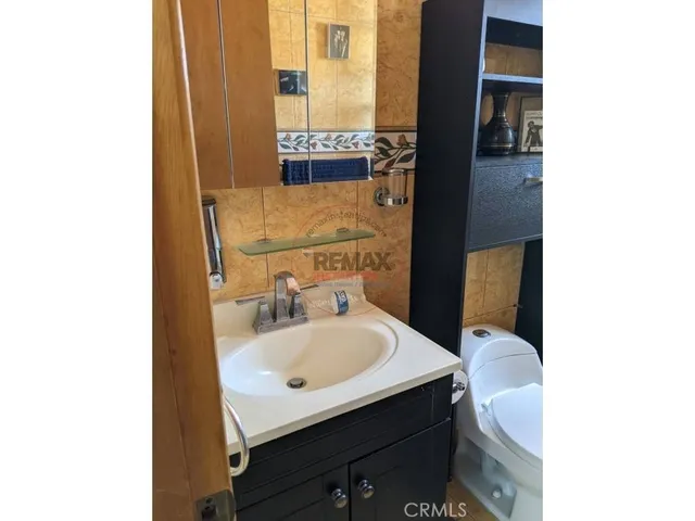 a bathroom with a toilet a sink and shower