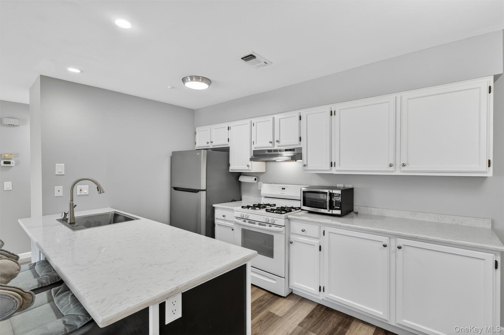 43 The Rise Warwick, NY 10990 - Photo 23 of 49 a kitchen with white cabinets stainless steel appliances and sink