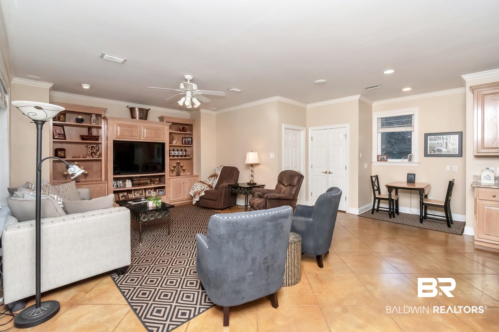 1050 Southern Way Court Mobile, AL 36609 - Photo 12 of 36 Living room featuring crown molding, ceiling fan, and light tile patterned floors