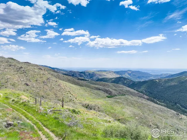 a view of a building with mountains in the background
