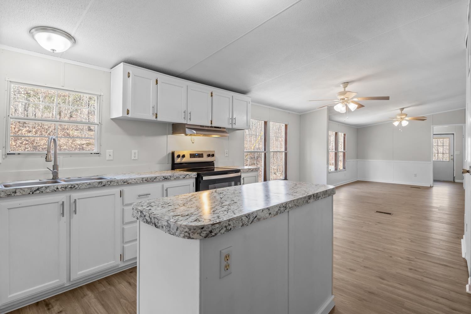 624 Nickletown Road Sugar Tree, TN 38380 - Photo 17 of 45 a kitchen with stainless steel appliances granite countertop a sink dishwasher a stove with wooden cabinets and floors