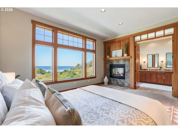 a bedroom with a large bed and a large window