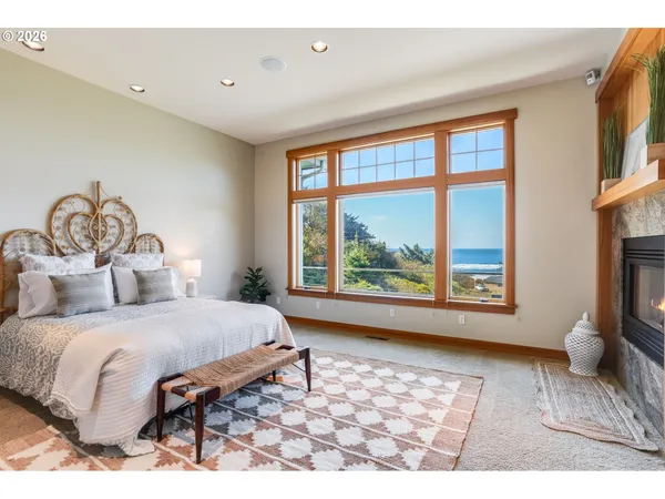 a bedroom with a large bed and a large window