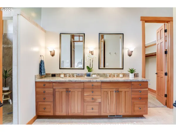a bathroom with a double vanity sink and a mirror