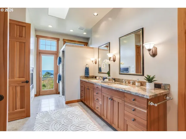 a bathroom with a sink a mirror and a shower