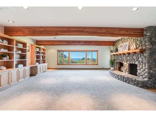 a view of livingroom with furniture fireplace and book shelf