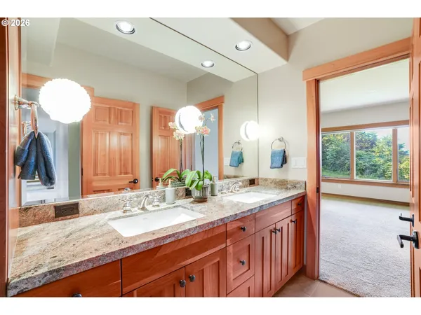 a bathroom with a granite countertop sink and a mirror
