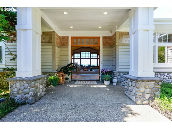 a view of front door with potted plants