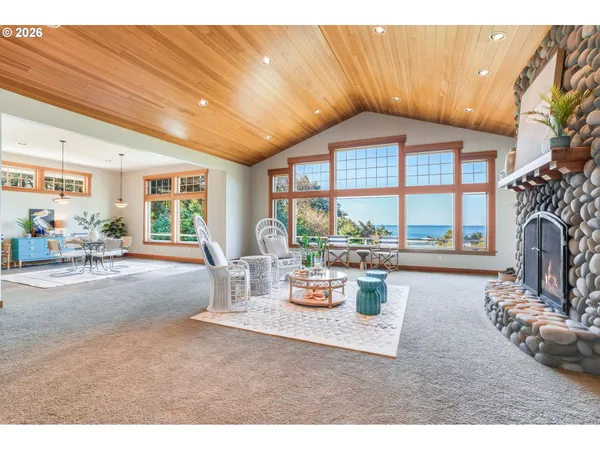 a living room with furniture a fireplace and a large window