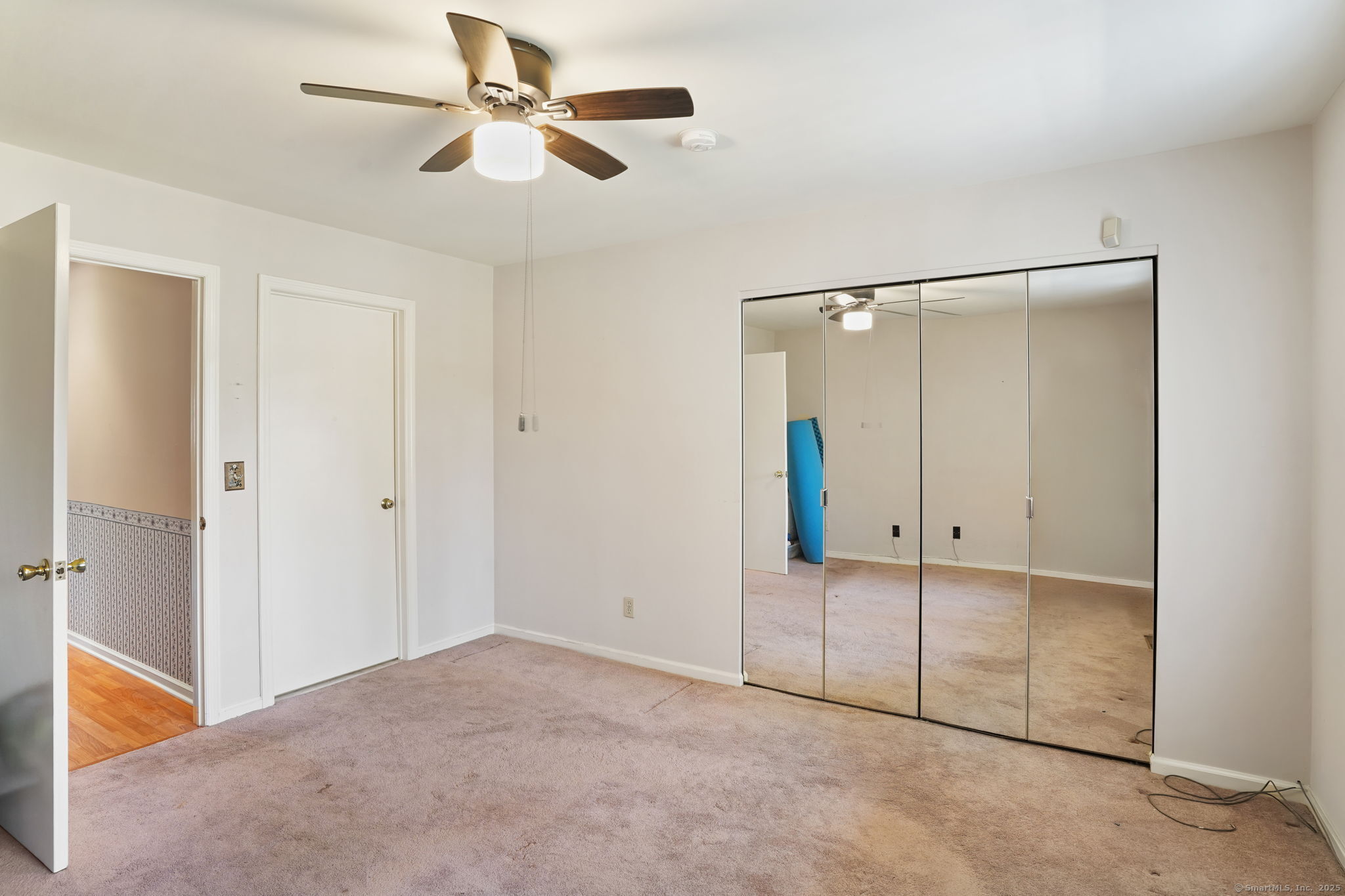 81 Lance Circle, Unit 81 Bridgeport, CT 06606 - Photo 12 of 24 a view of an empty room with a ceiling fan