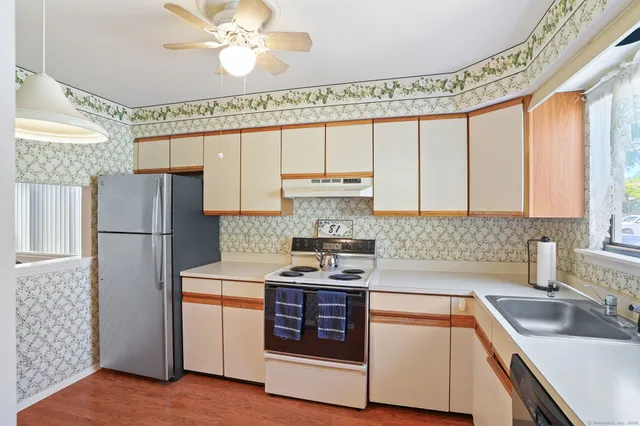 a kitchen with a stove a sink and a refrigerator