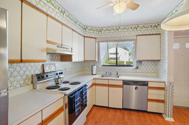 a kitchen with a sink stove and cabinets