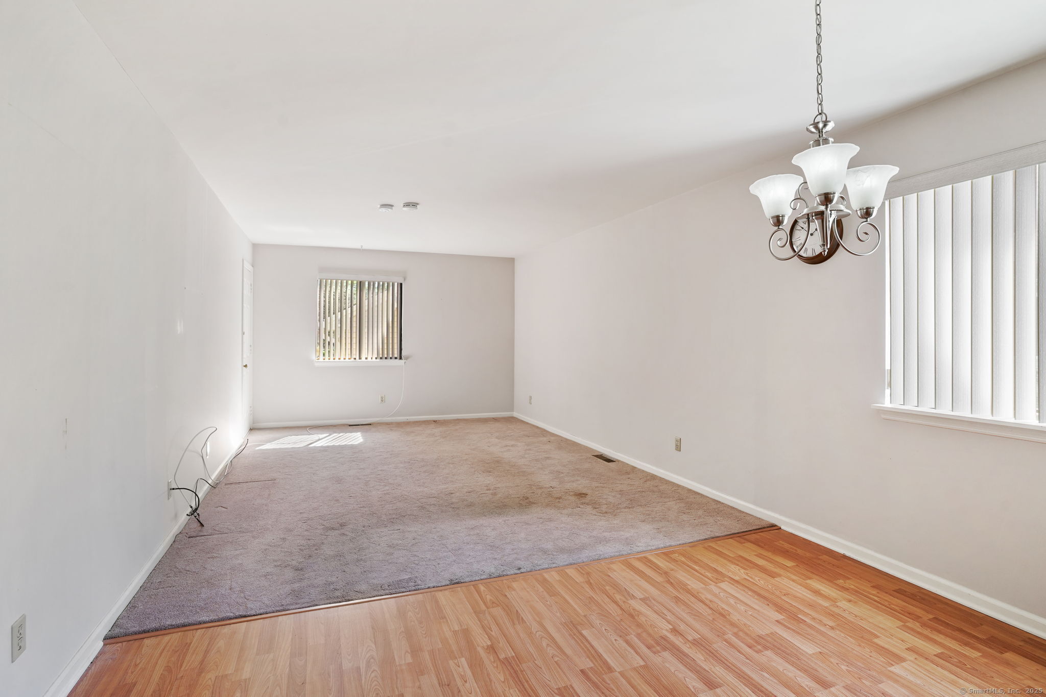 81 Lance Circle, Unit 81 Bridgeport, CT 06606 - Photo 6 of 24 an empty room with wooden floor cabinet and windows