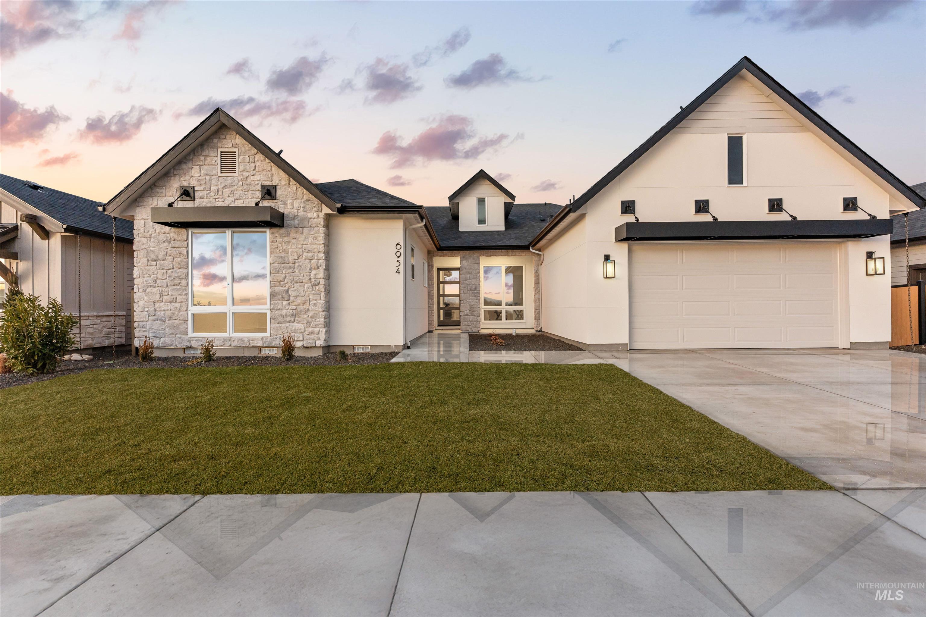 Contemporary exterior featuring a stone facade and white siding