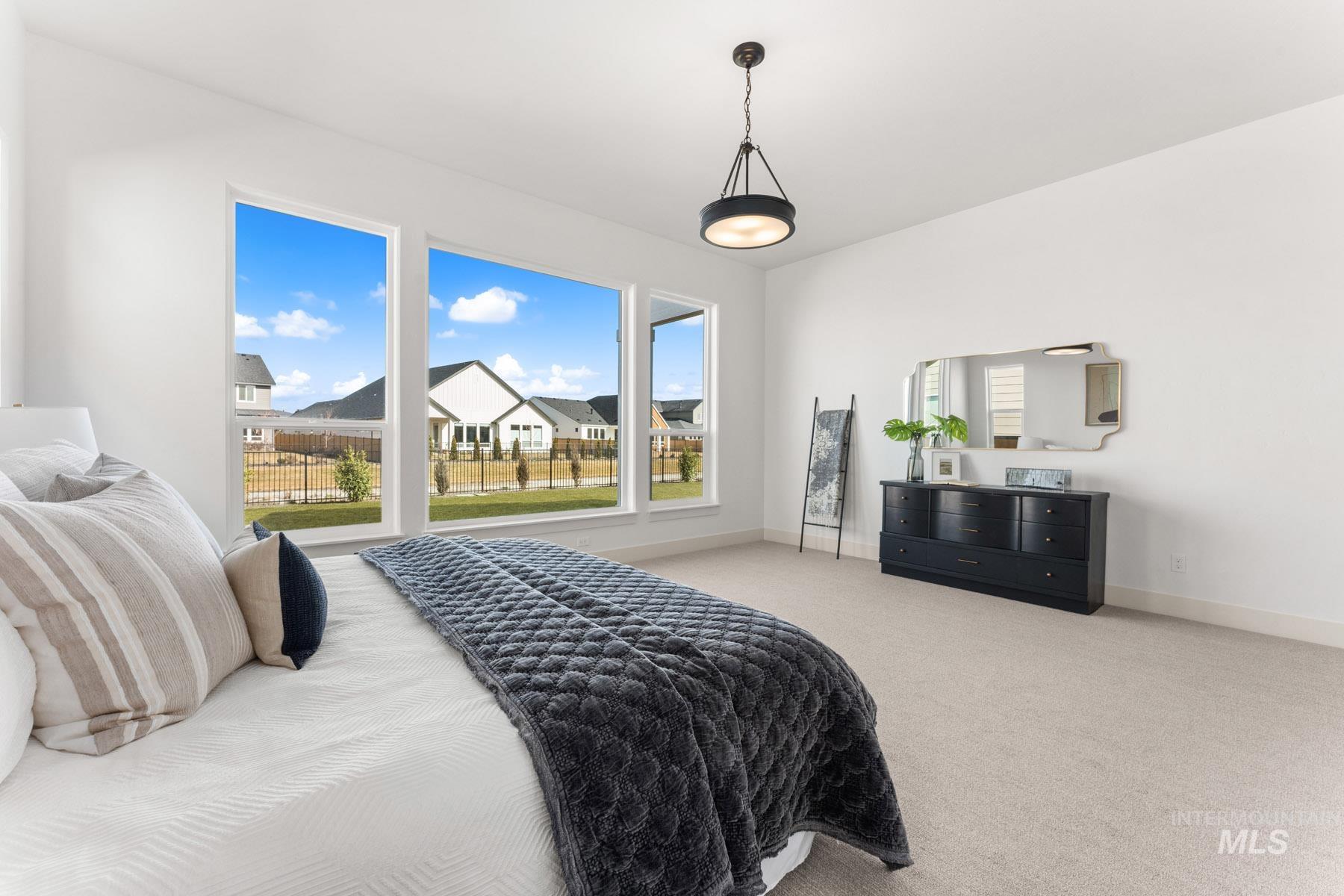 6954 Saddle Bred Way Star, ID 83669 - Photo 19 of 49 Bedroom with light carpet and baseboards