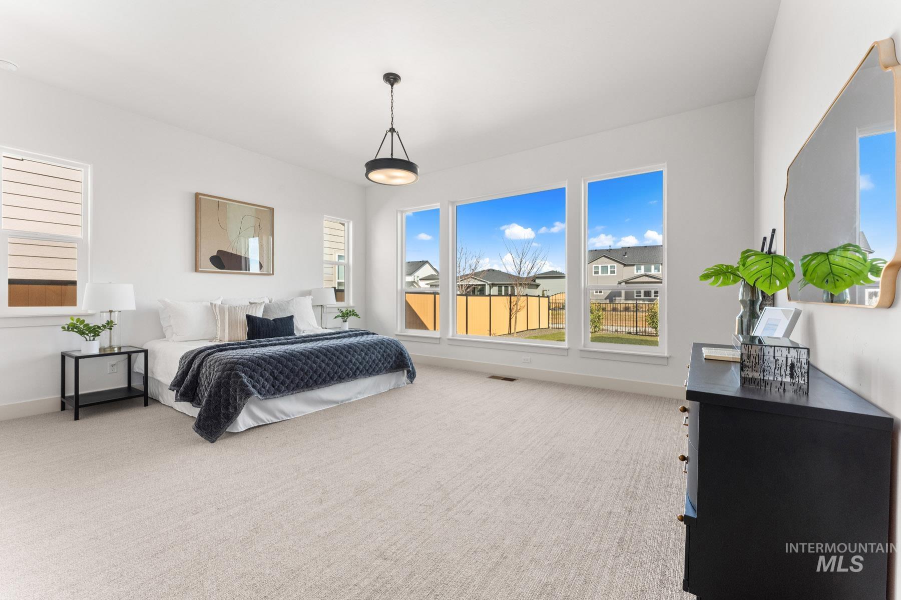 6954 Saddle Bred Way Star, ID 83669 - Photo 19 of 50 Bedroom with light carpet and multiple windows