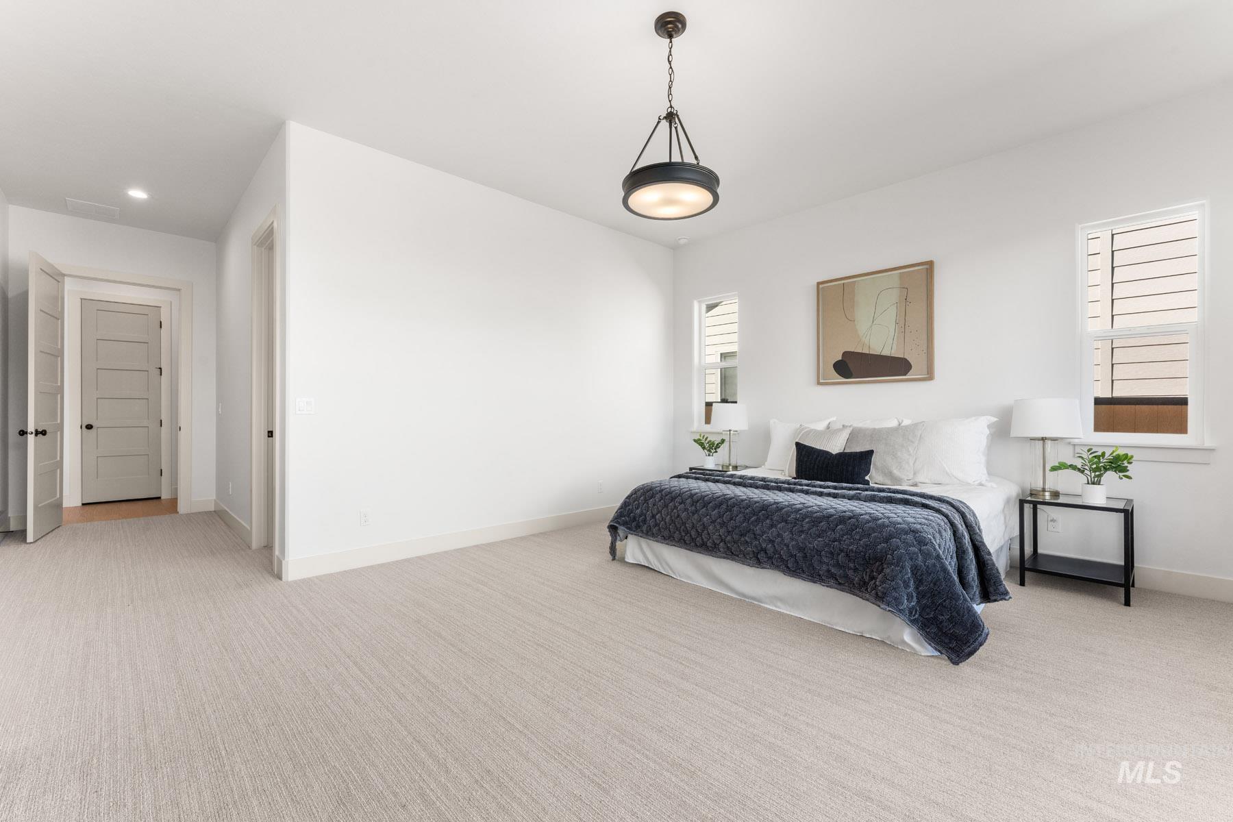 6954 Saddle Bred Way Star, ID 83669 - Photo 21 of 50 Bedroom with light colored carpet and baseboards