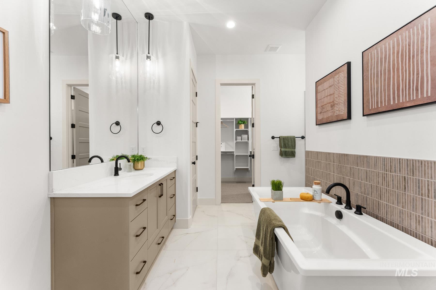 6954 Saddle Bred Way Star, ID 83669 - Photo 23 of 50 Full bathroom with a soaking tub, vanity, a spacious closet, light marble finish floors, and recessed lighting