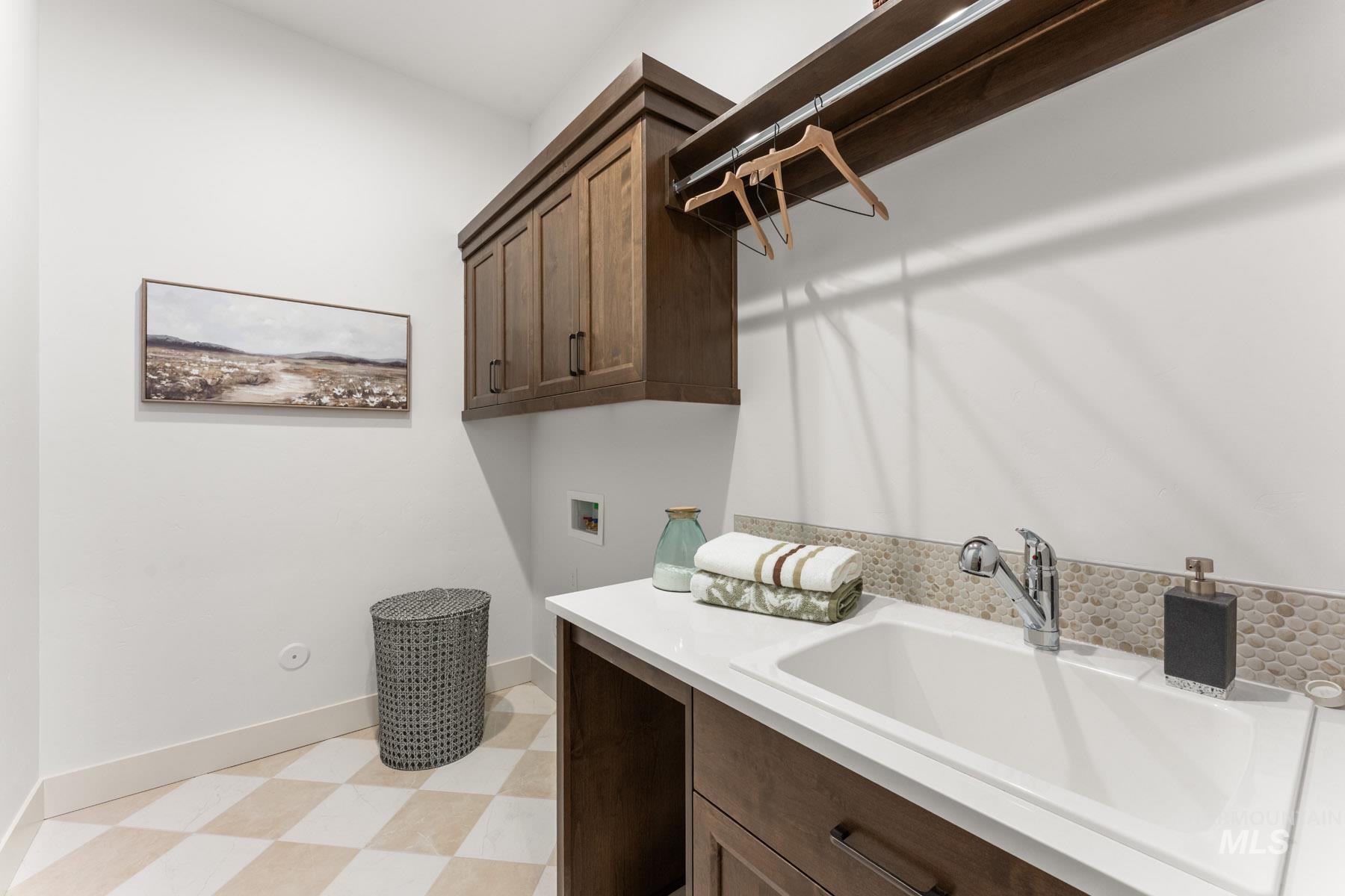 6954 Saddle Bred Way Star, ID 83669 - Photo 26 of 49 Laundry area with light floors, hookup for a washing machine, and cabinet space