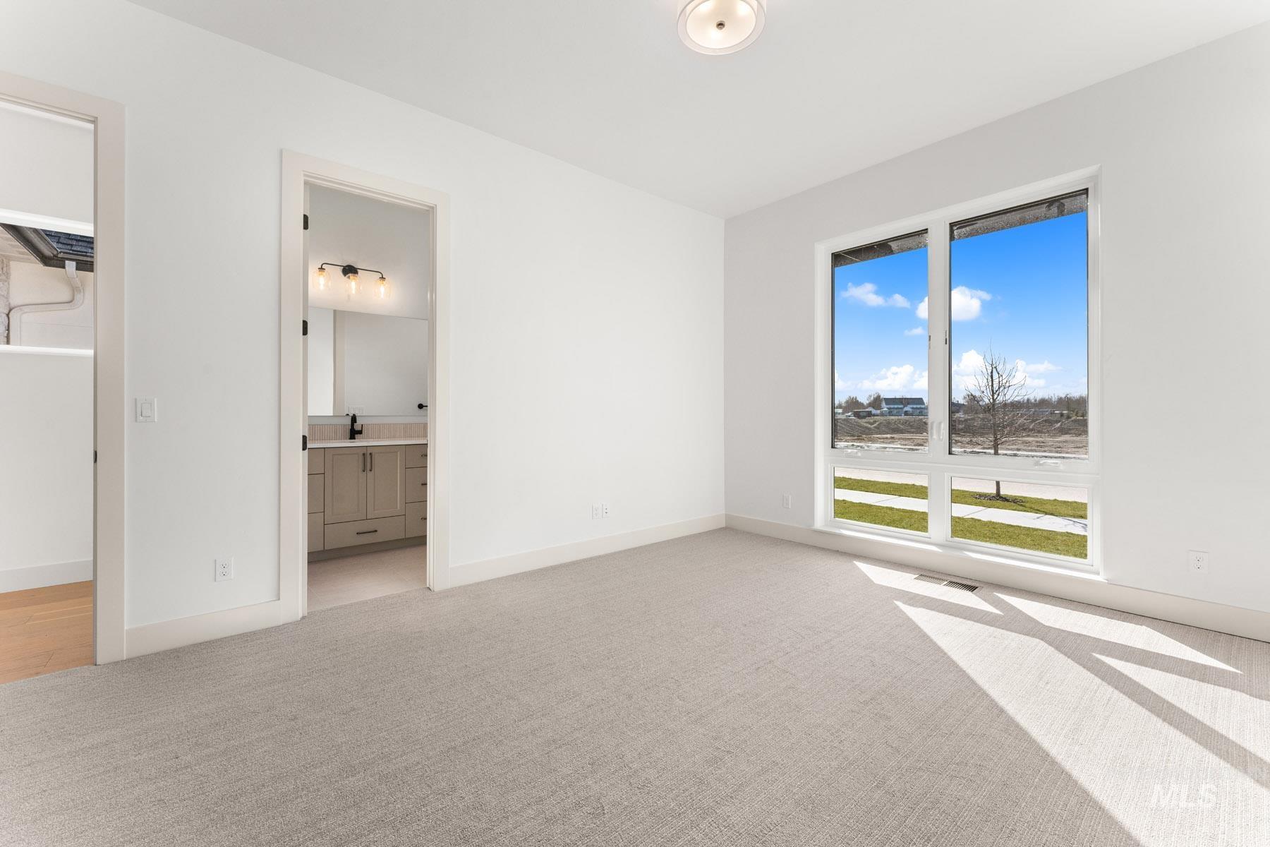6954 Saddle Bred Way Star, ID 83669 - Photo 28 of 49 Unfurnished bedroom with light carpet and ensuite bath