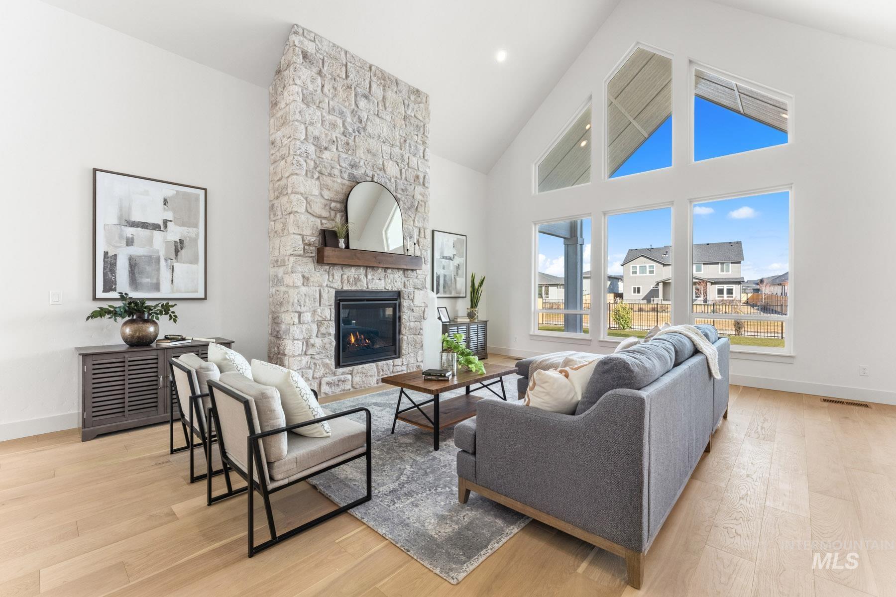 6954 Saddle Bred Way Star, ID 83669 - Photo 3 of 49 Living room featuring light wood-style floors, a fireplace, and vaulted ceiling