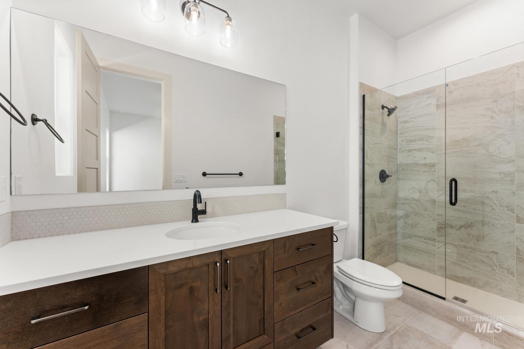 6954 Saddle Bred Way Star, ID 83669 - Photo 32 of 50 Bathroom with vanity, a shower stall, and light tile patterned floors