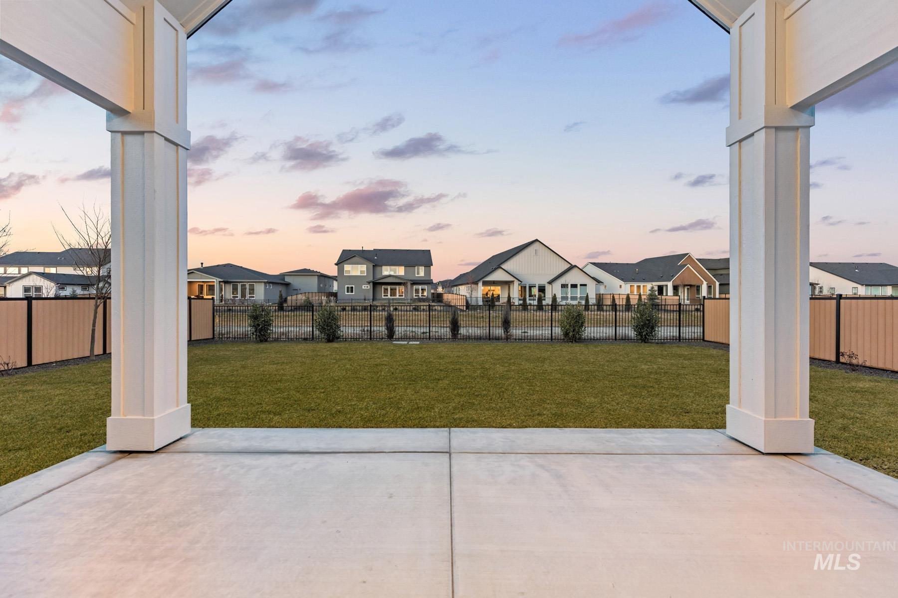 6954 Saddle Bred Way Star, ID 83669 - Photo 35 of 50 Patio terrace at dusk featuring a residential view, a patio area, and a fenced backyard
