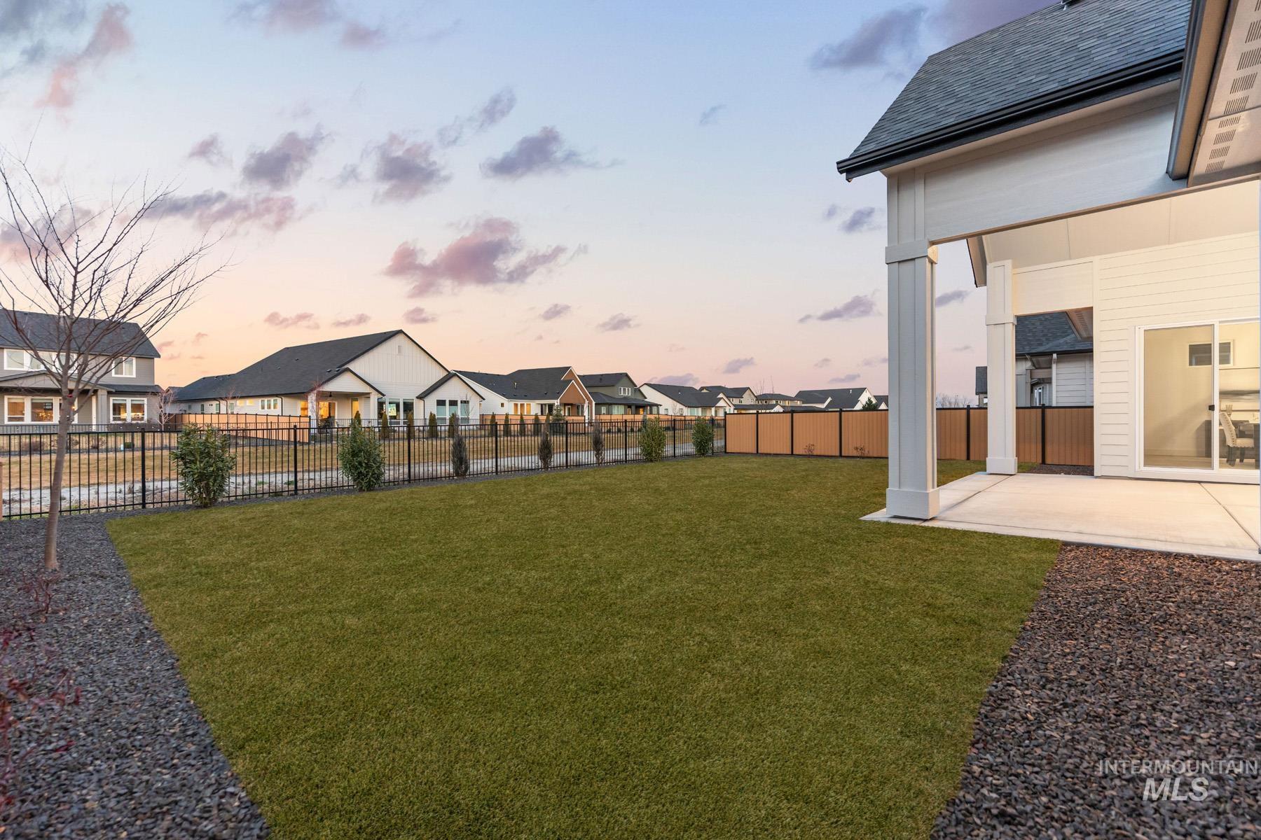 6954 Saddle Bred Way Star, ID 83669 - Photo 38 of 50 Fenced backyard with a patio area and a residential view