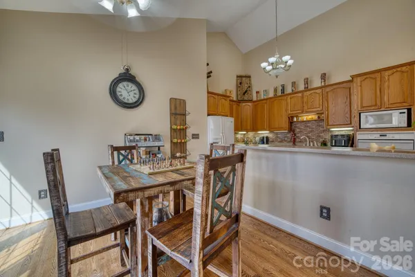 a kitchen with kitchen island a dining table and chairs
