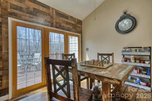 a view of a room with furniture and wooden floor