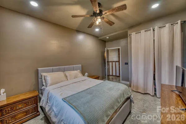 a bedroom with a large bed and a chandelier