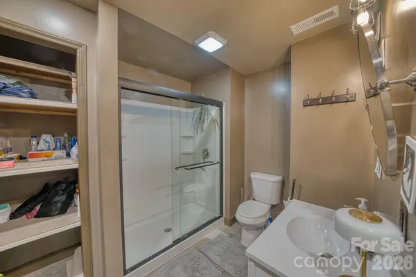 a bathroom with a toilet and a shower