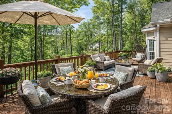 a view of a patio with furniture and table under an umbrella