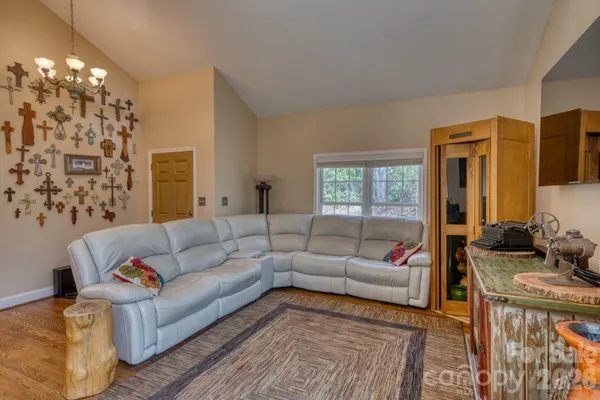 a living room with furniture and a chandelier