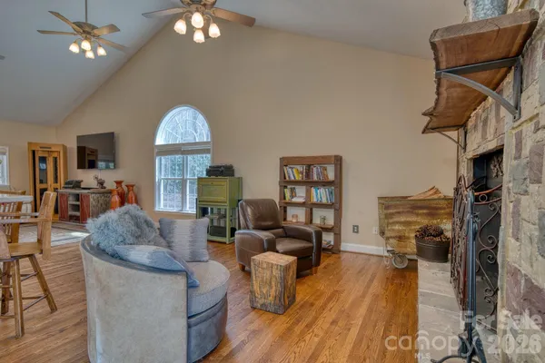 a living room with furniture a fireplace and a chandelier