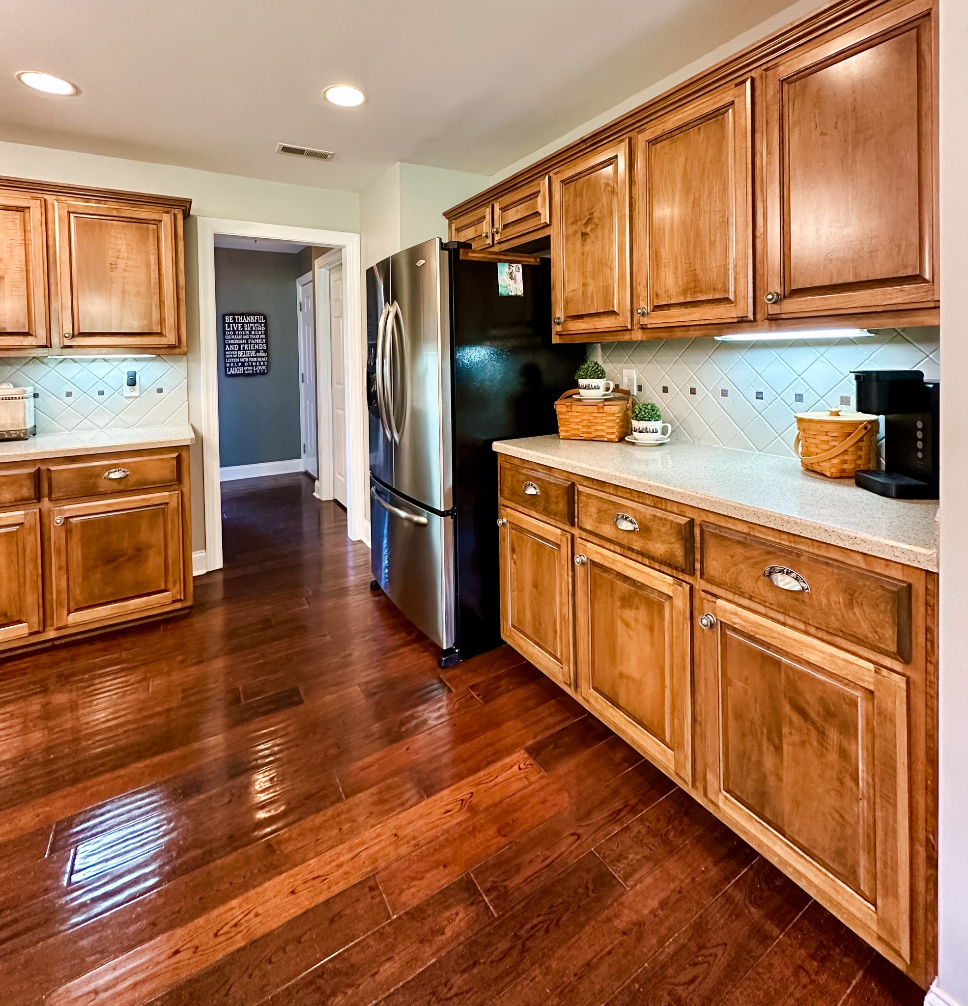 252 County House Hollow Road Cottontown, TN 37048 - Photo 32 of 50 a kitchen with granite countertop wooden floors stainless steel appliances and cabinets