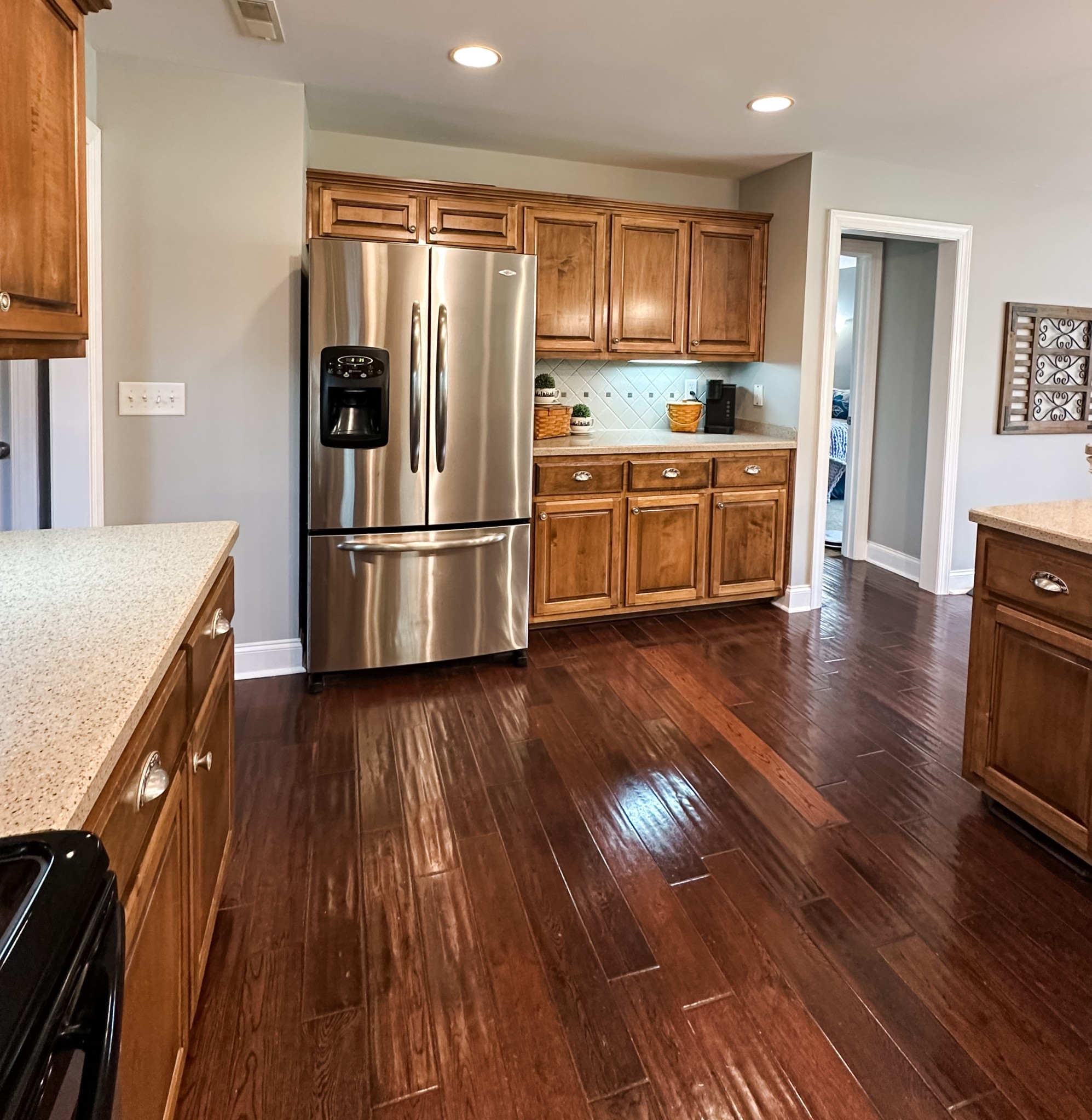 252 County House Hollow Road Cottontown, TN 37048 - Photo 33 of 50 a kitchen with stainless steel appliances wooden floors and wooden cabinets