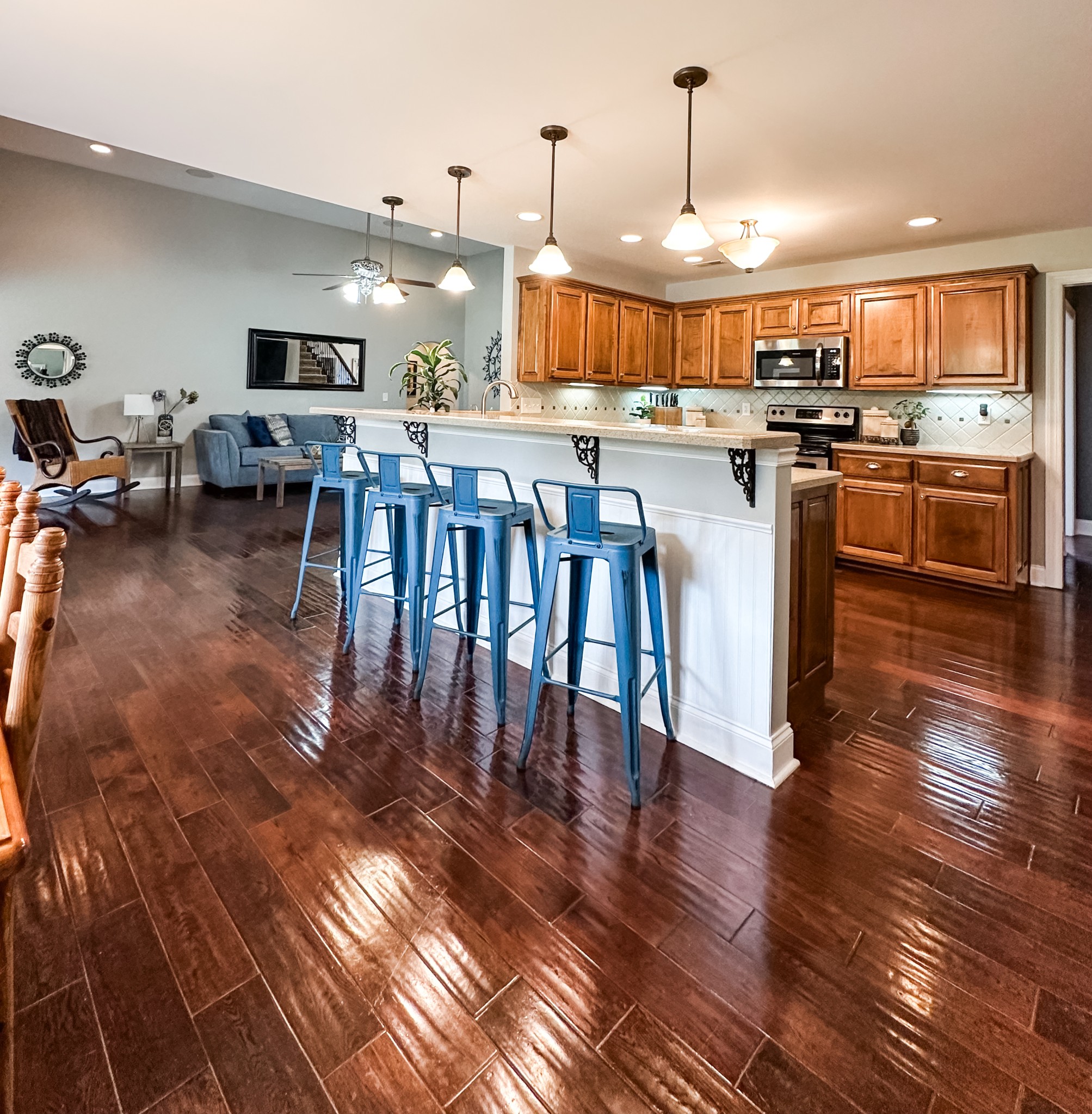252 County House Hollow Road Cottontown, TN 37048 - Photo 34 of 50 a kitchen with stainless steel appliances granite countertop a stove top oven a sink a dining table and chairs with wooden floor