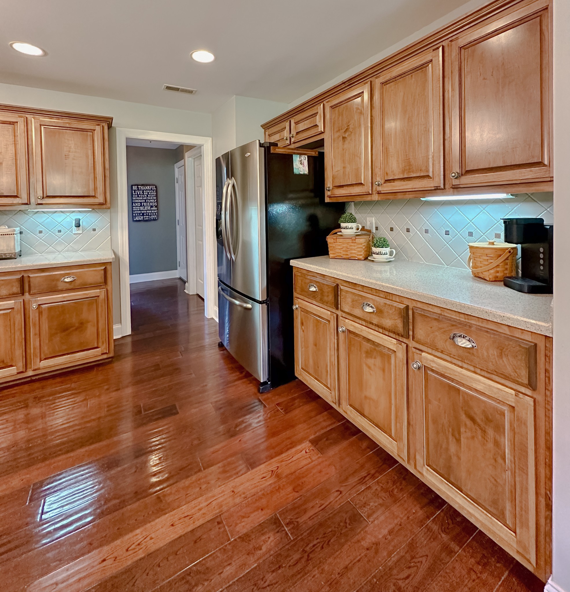 252 County House Hollow Road Cottontown, TN 37048 - Photo 36 of 50 a kitchen with granite countertop wooden cabinets and stainless steel appliances