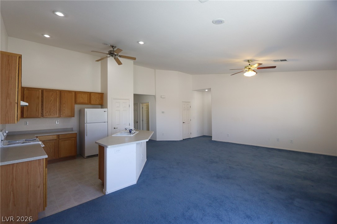 6472 Centennial Road Pahrump, NV 89048 - Photo 29 of 29 An open floorplan seamlessly connects the kitchen and living areas, offering effortless movement throughout the home.